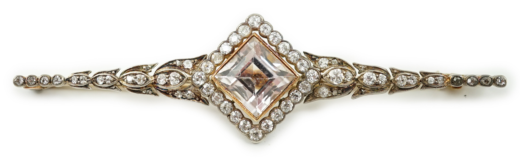 An early to mid 20th century gold and silver, pale pink topaz and millegrain set diamond cluster bar brooch